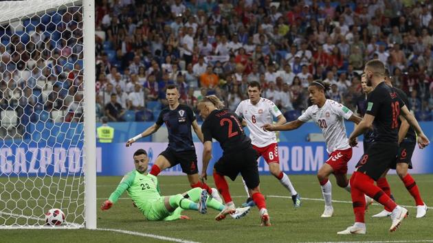 Croatia goalkeeper Danijel Subasic, left on the pitch, looks at the ball after Denmark's Mathias Jorgensen scored the opening goal. (AP) 