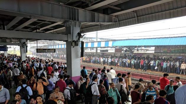 Commuters have been stranded at Borivali station as train services on Western and harbour lines have been hit. Mumbai’s dabbawalas have suspended all their tiffin box deliveries on Tuesday on the Western Railway (WR) routes, but will continue services on other routes. (HT Photo)