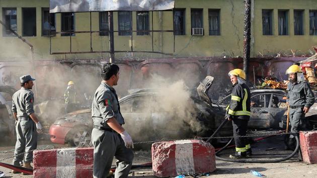 Afghan policemen inspect the site of a blast in Jalalabad city, Afghanistan, on July 1.(REUTERS)