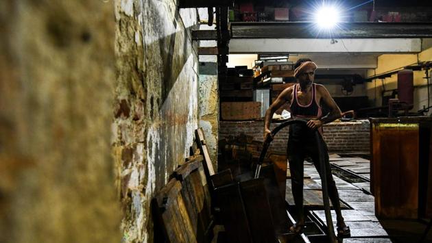 A labourer fills an ice block with water for freezing. Once sealed, the vessels are placed for 24 hours in large tanks filled with salt water, which has a lower freezing point than ordinary water and is chilled with ammonia.The containers are then taken out and workers extract the ice blocks, each weighing around 50 kilogrammes. (Chandan Khanna / AFP) A labourer fills an ice block with water for freezing. Once sealed, the vessels are placed for 24 hours in large tanks filled with salt water, which has a lower freezing point than ordinary water and is chilled with ammonia.The containers are then taken out and workers extract the ice blocks, each weighing around 50 kilogrammes. (Chandan Khanna / AFP)