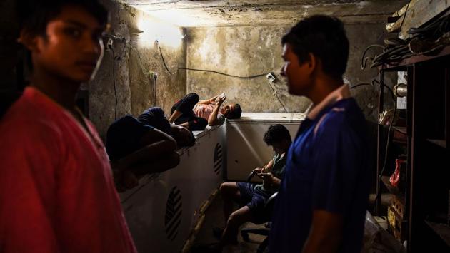 Workers rest inside a store room in an ice factory in Noida. Shreeram Yadav who is the supervisor at the factory said, “Some will buy 50 blocks, some will buy 10, some five, some 25.” “They go everywhere, and they’re sold in different quantities. We sell it to the distributors, and then the distributors sell them in pieces,” he added. (Chandan Khanna / AFP) Workers rest inside a store room in an ice factory in Noida. Shreeram Yadav who is the supervisor at the factory said, “Some will buy 50 blocks, some will buy 10, some five, some 25.” “They go everywhere, and they’re sold in different quantities. We sell it to the distributors, and then the distributors sell them in pieces,” he added. (Chandan Khanna / AFP)