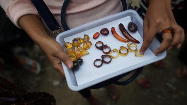 Some sell rough-edged uncut chunks. Others tout finished products: pendants, necklaces and bracelets made from carefully polished pieces. The trading takes place just a few dozen kilometres from the fighting between Myanmar’s army and ethnic Kachin rebels battling for autonomy, land, identity -- and natural resources that help finance both sides. (Ye Aung Thu / AFP) 