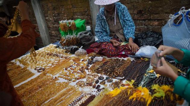 “We almost could not reach the mining area because it was very dangerous,” Lida Xing says of his 2015 trip when he brought back part of a feathered dinosaur tail to China from Myanmar that dated back some 99 million years. “We sneaked in when the situation eased quite a lot, but no scientist was able to go inside after that.” (Ye Aung Thu / AFP) 