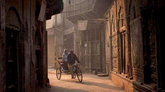 A man pedals a rickshaw carrying a passenger in the old parts of Delhi.(HT File)