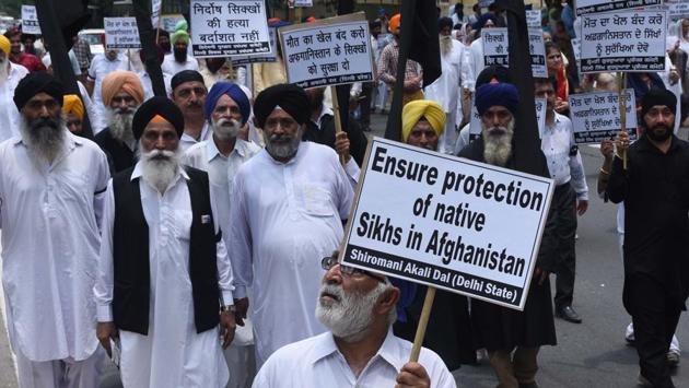 Members of the Sikh community hold placards during a protest march at Afghan High Commission against the attack on the Sikh community in Afghanistan, in New Delhi. (Vipin Kumar / HT Photo)