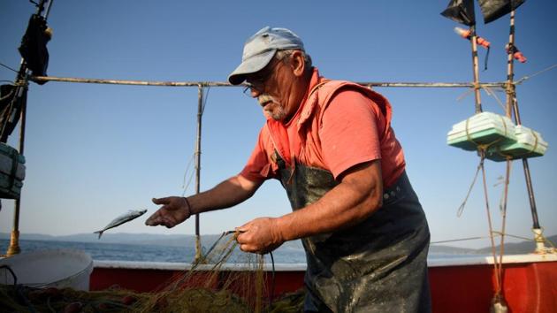 Dimitris Karapetsas, 67, fishes onboard ‘Katerina’ off the shores of Asprovalta. “I have been doing this job for 67 years. I have travelled to practically all of Greece, and now, I have reached my limitations,” Pagonis said. “I feel sad, I didn’t want it to end this way.” (Alexandros Avramidis / REUTERS)
