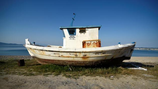 A boat that is to be destroyed is seen at the port town of Ierissos, Greece. “The sea is my entire life,” said 48-year-old Stelios Didonis. He looks forward to resting for a month, tired from getting up at 4:00 am for 30 years. But he is not sure what he will do after that. (Alexandros Avramidis / REUTERS)