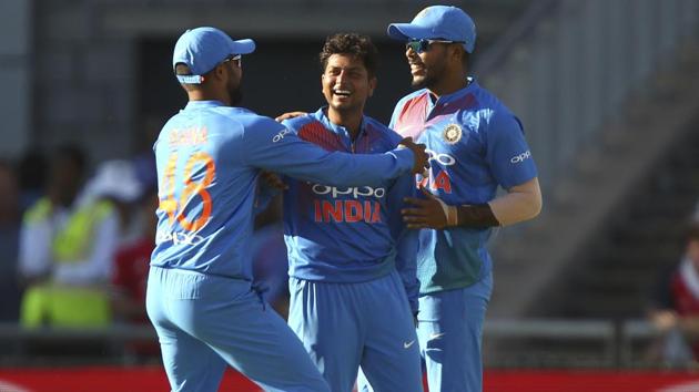 India's Kuldeep Yadav, centre, celebrates taking the wicket of England's Joe Root during the first T20 at the Old Trafford cricket ground in Manchester.(AP)