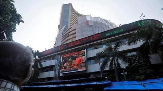 People watch a large screen displaying India's benchmark share index on the facade of the Bombay Stock Exchange (BSE) building in Mumbai.(Reuters File Photo)