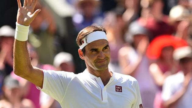 Switzerland's Roger Federer celebrates after beating Serbia's Dusan Lajovic 6-1, 6-3, 6-4 in their men's singles first round match on the first day of the 2018 Wimbledon Championships.(AFP)