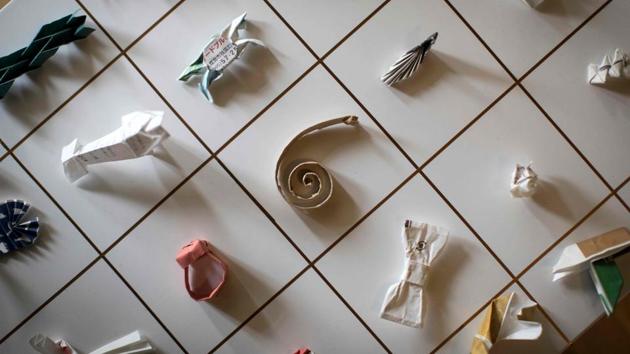 A collection of origami made from chopstick sleeves maintained by Yuki Tatsumi in Kameoka, Kyoto. Tatsumi was waiting tables at a pub when something on the table caught his eye -- a chopstick wrapper folded and fiddled into an abstract shape. It was the catalyst for a collection that now includes 15,000 pieces of found “origami art” made by restaurant customers from paper sleeves that cover chopsticks. (Harumi Ozawa / AFP) A collection of origami made from chopstick sleeves maintained by Yuki Tatsumi in Kameoka, Kyoto. Tatsumi was waiting tables at a pub when something on the table caught his eye -- a chopstick wrapper folded and fiddled into an abstract shape. It was the catalyst for a collection that now includes 15,000 pieces of found “origami art” made by restaurant customers from paper sleeves that cover chopsticks. (Harumi Ozawa / AFP)