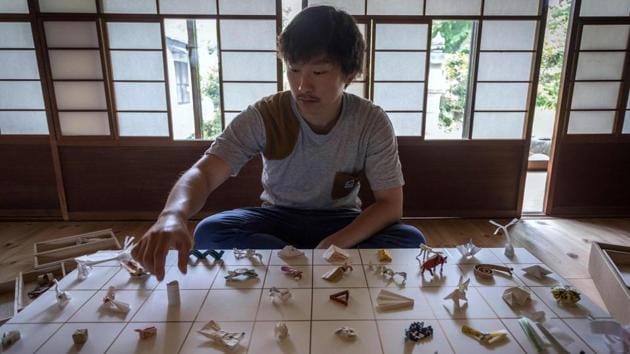 Yuki Tatsumi sits next to his collection of origami made from chopstick sleeves. “The very first one I found just looked like a bit of junk,” 27-year-old Tatsumi admitted, but it made him think. Tipping at restaurants is not standard in Japan, but Tatsumi came to see these folded paper pieces left behind by customers as a “Japanese tip”, and started watching out for different types. (Harumi Ozawa / AFP) Yuki Tatsumi sits next to his collection of origami made from chopstick sleeves. “The very first one I found just looked like a bit of junk,” 27-year-old Tatsumi admitted, but it made him think. Tipping at restaurants is not standard in Japan, but Tatsumi came to see these folded paper pieces left behind by customers as a “Japanese tip”, and started watching out for different types. (Harumi Ozawa / AFP)