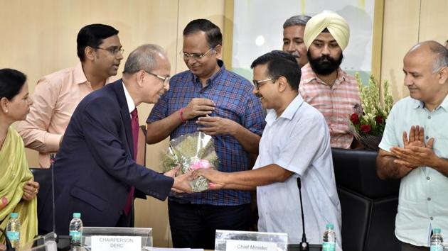 Delhi Chief Minister, Arvind Kejriwal greets justice (retired) Satyendra Singh Chauhan during his oath taking ceremony as the Delhi Electricity Regulatory Commission chairperson at Delhi Secretariat, in the presence of deputy chief minister Manish Sisodia, power minister Satyendar Jain and others. (Sonu Mehta / HT Photo)
