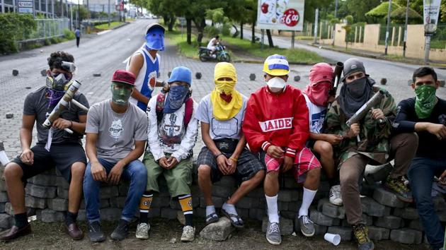 In some neighbourhoods, students created brick and concrete barricades to keep out riot police and pro-government forces who have used tear gas, rubber bullets and even live ammunition to attack protesters. (Esteban Felix / AP)