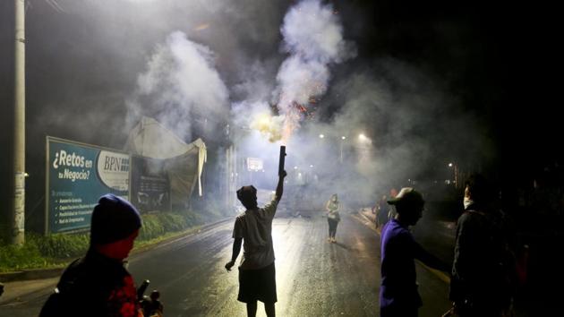 Chavarria’s mother and relatives buried his body in Managua. At the funeral, some carried the Nicaraguan flag upside-down, a symbol of national distress, while others fired homemade mortars into the night sky. (Esteban Felix / AP)