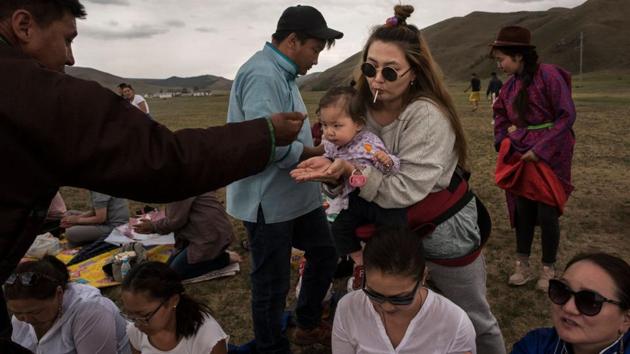 A follower of Shamanism takes rice as a blessing during a ceremony. While there is no concrete history of Mongolian Shamanism’s origins, as Buddhism gained dominance backed by the influence of the Yuan Dynasty, shamanistic traditions found themselves transformed into a sociocultural hybrid. (Kevin Frayer / Getty Images) A follower of Shamanism takes rice as a blessing during a ceremony. While there is no concrete history of Mongolian Shamanism’s origins, as Buddhism gained dominance backed by the influence of the Yuan Dynasty, shamanistic traditions found themselves transformed into a sociocultural hybrid. (Kevin Frayer / Getty Images)