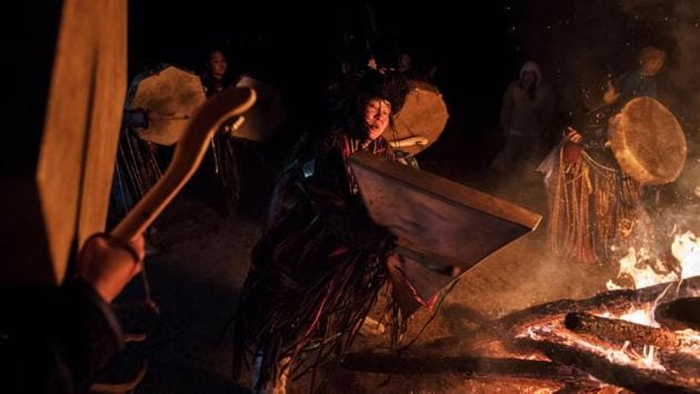 The ritual proceeds with participants on the edge coming forward into the circle and asking the spirits a solution for their problems. The ceremonial leaders then encircle the fire and the bags containing letters are hurled away. (Kevin Frayer / Getty Images) The ritual proceeds with participants on the edge coming forward into the circle and asking the spirits a solution for their problems. The ceremonial leaders then encircle the fire and the bags containing letters are hurled away. (Kevin Frayer / Getty Images)