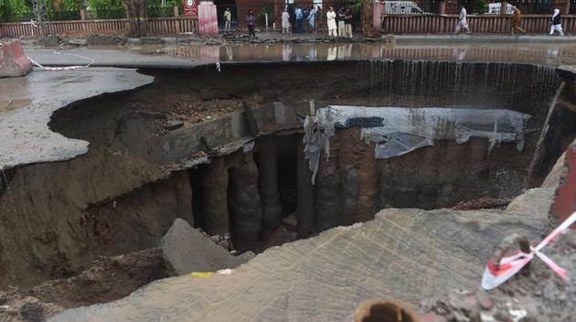 A road in Lahore caved in due to heavy rains.(AFP)