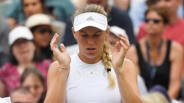 Denmark's Caroline Wozniacki reacts after loosing her Wimbledon second round match against Russia's Ekaterina Makarova. (REUTERS)