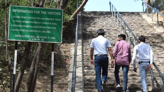 On the information board installed outside Sukhna lake,visiting hours have been removed.(HT Photo)