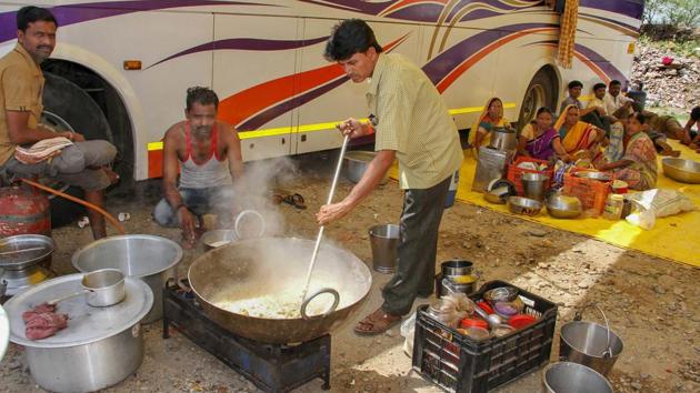Stranded Amaranth pilgrims prepare food at their base camp, in Jammu on Friday. The pilgrimage remained suspended for the third consecutive day on Friday due to bad weather. Pilgrims were not permitted to move from Jammu towards the shrine’s Baltal and Pahalgam base camps in Kashmir Valley. (PTI) Stranded Amaranth pilgrims prepare food at their base camp, in Jammu on Friday. The pilgrimage remained suspended for the third consecutive day on Friday due to bad weather. Pilgrims were not permitted to move from Jammu towards the shrine’s Baltal and Pahalgam base camps in Kashmir Valley. (PTI)