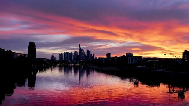 The sun sets over the banking district and the river Main in Frankfurt, Germany. (Michael Probst / AP)