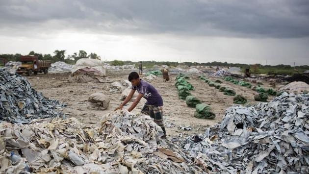 A worker gathers strips of leather salvaged from waste. New York-based Transparentem, a labour rights group, is calling on American and European companies that sourced leather in Hazaribagh — or had items made by companies that also owned tanneries there — to help clean up the mess. The companies include Clarks, Coach, Kate Spade, Macy’s, Michael Kors, Sears, Steven Madden and Timberland. (A.M Ahad / AP) A worker gathers strips of leather salvaged from waste. New York-based Transparentem, a labour rights group, is calling on American and European companies that sourced leather in Hazaribagh — or had items made by companies that also owned tanneries there — to help clean up the mess. The companies include Clarks, Coach, Kate Spade, Macy’s, Michael Kors, Sears, Steven Madden and Timberland. (A.M Ahad / AP)