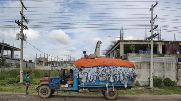 A worker sits on top of tannery waste loaded in a truck at Tannery Industrial Area. Supply chains take a few steps, sometimes dozens, to get from the source of a product to an item on a store shelf. Transparentem is also calling on buyers to use their collective leverage to advocate for better waste treatment facilities in Savar. (A.M Ahad / AP) A worker sits on top of tannery waste loaded in a truck at Tannery Industrial Area. Supply chains take a few steps, sometimes dozens, to get from the source of a product to an item on a store shelf. Transparentem is also calling on buyers to use their collective leverage to advocate for better waste treatment facilities in Savar. (A.M Ahad / AP)
