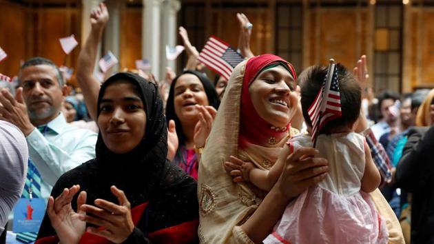 New citizens smile at a US Citizenship and Immigration Services (USCIS) naturalization ceremony at the New York Public Library in Manhattan, New York. (Shannon Stapleton / REUTERS)