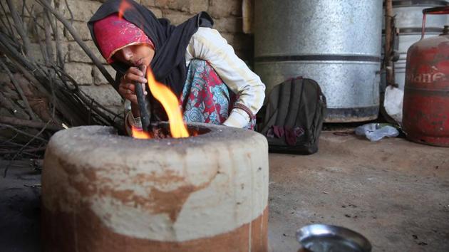 Despite getting an LPG connection under Pradhan Mantri Ujjwala Yojana in June 2016, Hansa, at Sitarampura village in Jaipur, is back to stoking the fire in her earthen stove for cooking as she could afford only one refill in two years.(Himanshu Vyas/HT Photos)