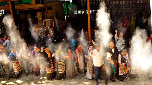 Tibetans in exile hurl flour during a prayer session on the occasion of the Dalai Lama’s birthday in McLeodganj. Special prayers were also held in Ladakh in the presence of the spiritual leader who is expected to remain in the mountainous region till the end of July. (Shyam Sharma / HT Photo) 