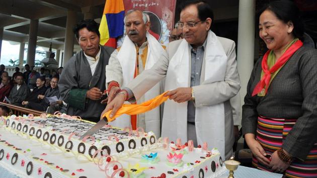 Food, civil supplies and consumer affairs minister from the state of Himachal Pradesh Kishan Kapoor along with Tibetans in exile cut a birthday cake as they celebrate the birthday of the Dalai Lama at a temple. (Shyam Sharma / HT Photo) 
