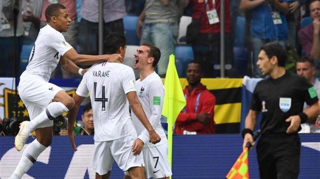 Raphael Varane (2nd L) celebrates with Antoine Griezmann (2ndR) and Kylian Mbappe after scoring the opener for France during the FIFA World Cup 2018 quarterfinal against Uruguay.(AFP)