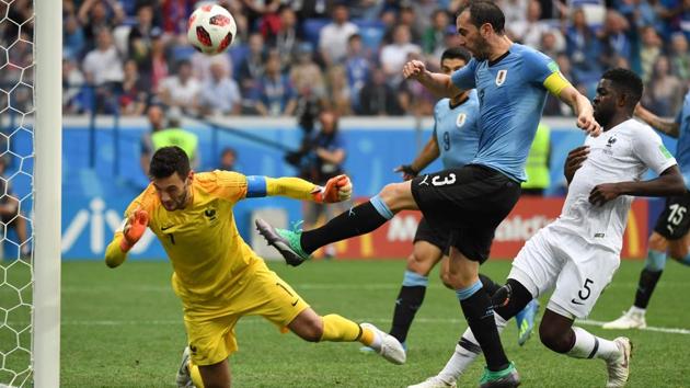 Uruguay's defender Diego Godin (C) kicks the ball past France's goalkeeper Hugo Lloris (L) and France's defender Samuel Umtiti. (AFP)