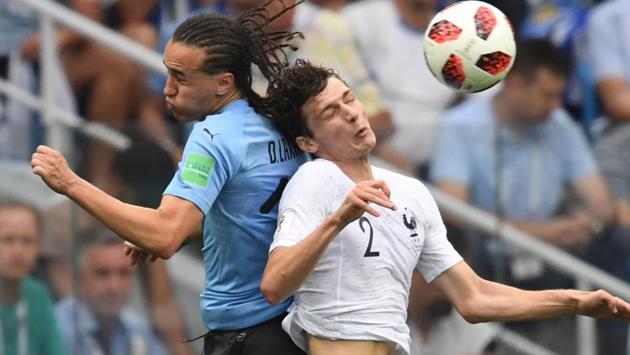 Uruguay's defender Diego Laxalt (L) heads the ball. (AFP)