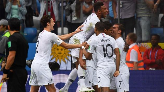 France's players celebrate their opening goal during the 2018 FIFA World Cup quarter-final football match between Uruguay and France at the Nizhny Novgorod Stadium in Nizhny Novgorod on July 6, 2018. France won 2-0. (AFP)