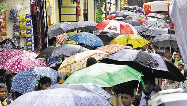 Residents were ready for the rains and this street in upper Indiranagar wore a vibrant look with many sporting colourful umbrellas. (Rahul Raut/HT PHOTO) Residents were ready for the rains and this street in upper Indiranagar wore a vibrant look with many sporting colourful umbrellas. (Rahul Raut/HT PHOTO)