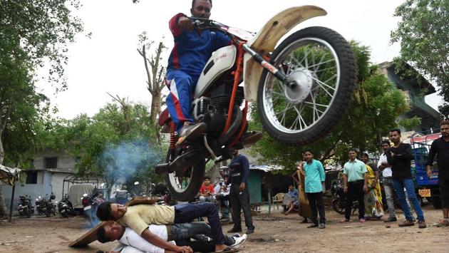 Stunt biker Kalpesh Modi rehearses a jump ahead of the annual Rath Yatra of Lord Jagannath in Ahmedabad, Gujarat on July 3, 2018. (Sam Panthaky / AFP)
