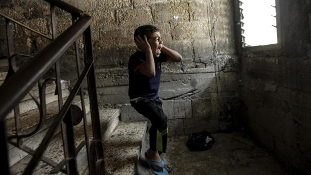 Brother of Palestinian Mahmud al-Ghrabli 16, cries during his funeral procession in Gaza City. The teen was shot by Israeli forces in May during major clashes on the Gaza border and died of his wounds. (Mahmud Hams / AFP)