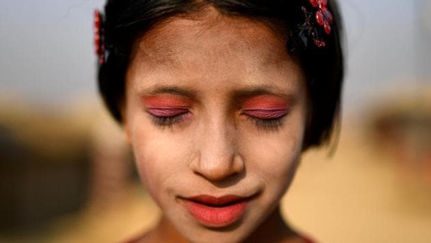 A Rohingya refugee girl named Amina poses for a photograph at Kutupalong camp in Cox's Bazaar. Swirls of yellow paste made from ground tree bark decorate the cheeks of Rohingya women and girls in the refugee camps of southern Bangladesh. (Clodagh Kilcoyne / REUTERS) A Rohingya refugee girl named Amina poses for a photograph at Kutupalong camp in Cox's Bazaar. Swirls of yellow paste made from ground tree bark decorate the cheeks of Rohingya women and girls in the refugee camps of southern Bangladesh. (Clodagh Kilcoyne / REUTERS)