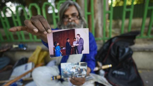 Rao shows an old photograph of him receiving his Civil Engineering degree. “This is my institute,” he said, sitting under the shade of a tree by the footpath. He recalls his professional life as an angry one, in contrast to his days now, free from anguish and spent in temples, ashrams or the Andhra Bhawan’s grounds. (Burhaan Kinu / HT Photo)