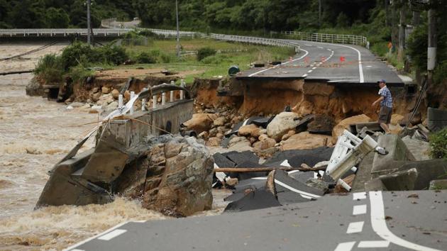 A road collapsed due to heavy rain in Higashihiroshima, Hiroshima prefecture on July 7. (AFP Photo) A road collapsed due to heavy rain in Higashihiroshima, Hiroshima prefecture on July 7. (AFP Photo)