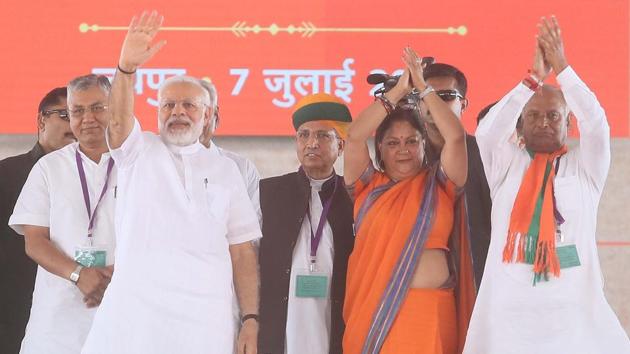 PM Narendra Modi, CM Vasundhara Raje and newly-appointed state BJP president Madanlal Saini greet people at Amrudon Ka Bagh in Jaipur on Saturday. (Himanshu Vyas/HT Photo) PM Narendra Modi, CM Vasundhara Raje and newly-appointed state BJP president Madanlal Saini greet people at Amrudon Ka Bagh in Jaipur on Saturday. (Himanshu Vyas/HT Photo)