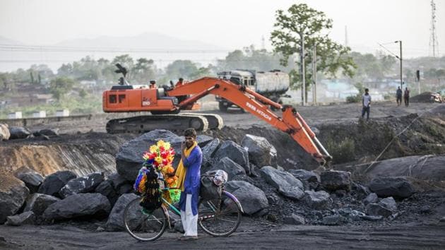 A festoon seller sits on a bicycle as an excavator operates at the Tori Siding. The Railways earn revenue of Rs 100 crore for every 1 MT of coal transported to about 500 km. Even if 100 MT is to be transported by Tori-Shivpur, this railway line is expected to generate about Rs 10,000 crore per annum. (Prashanth Vishwanathan / Bloomberg) A festoon seller sits on a bicycle as an excavator operates at the Tori Siding. The Railways earn revenue of Rs 100 crore for every 1 MT of coal transported to about 500 km. Even if 100 MT is to be transported by Tori-Shivpur, this railway line is expected to generate about Rs 10,000 crore per annum. (Prashanth Vishwanathan / Bloomberg)