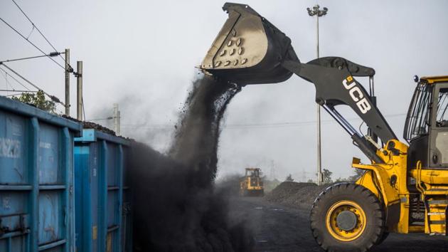 A JC Bamford Excavators Ltd. (JCB) front loader loads coal onto a freight wagon at the Tori Siding on the Tori-Shivpur rail line. Coal from North Karanpura mines will move through the Tori-Shivpur corridor to power generation plants at a distance of 200-300 kilometres and also much further away at 1,200kms to Punjab. (Prashanth Vishwanathan / Bloomberg) A JC Bamford Excavators Ltd. (JCB) front loader loads coal onto a freight wagon at the Tori Siding on the Tori-Shivpur rail line. Coal from North Karanpura mines will move through the Tori-Shivpur corridor to power generation plants at a distance of 200-300 kilometres and also much further away at 1,200kms to Punjab. (Prashanth Vishwanathan / Bloomberg)