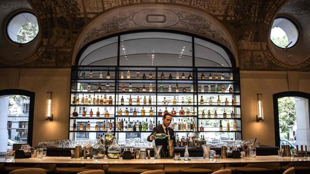 A bartender prepares a drink at the bar of the newly-refurbished Lutetia Hotel in Paris.(AFP)