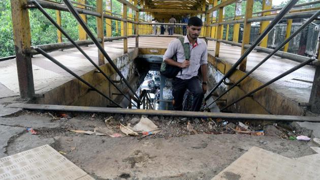 A pedestrian walks on the dilapidated Kalyan skywalk on Friday. The tiles on the skywalk have come off, while the shed has gone missing at one end of the skywalk. (Rishikesh Choudhary/ Hindustan Times) A pedestrian walks on the dilapidated Kalyan skywalk on Friday. The tiles on the skywalk have come off, while the shed has gone missing at one end of the skywalk. (Rishikesh Choudhary/ Hindustan Times)