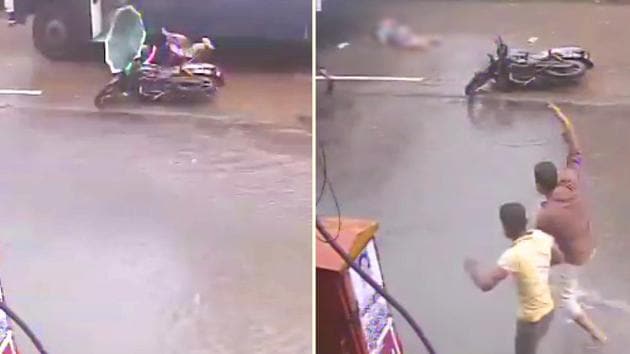 The two-wheeler can be seen slipping as it goes over a pothole on the waterlogged road and both the rider and pillion fall to their right.(Screengrab)
