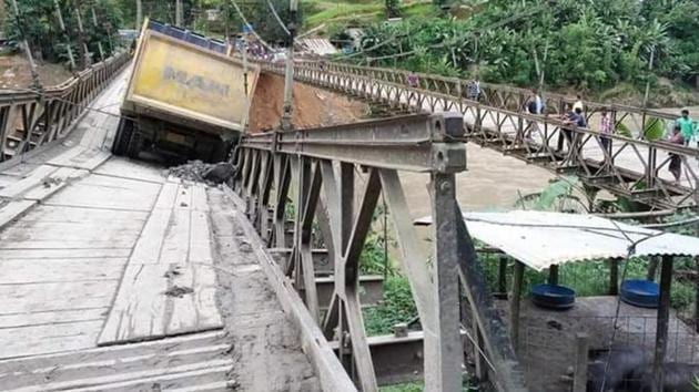 The bridge over Barak River along the Imphal-Jiribam sector of NH 37 was damaged when a loaded truck was passing on Sunday morning while a stretch of around 100 metre of the busy Kohima-Dimapur sector of NH 29 near Nagaland’s state capital sank in the intervening night of Saturday and Sunday following incessant rain in the last few days. (HT Photo) The bridge over Barak River along the Imphal-Jiribam sector of NH 37 was damaged when a loaded truck was passing on Sunday morning while a stretch of around 100 metre of the busy Kohima-Dimapur sector of NH 29 near Nagaland’s state capital sank in the intervening night of Saturday and Sunday following incessant rain in the last few days. (HT Photo)