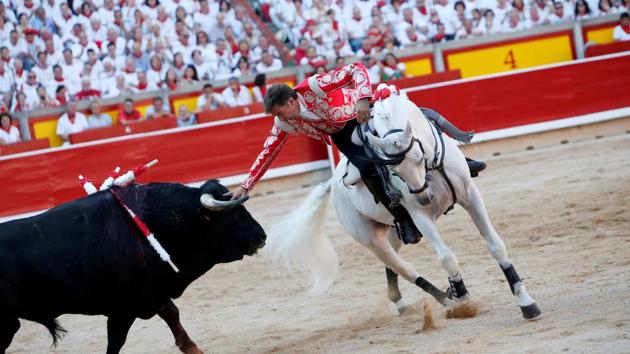 Spanish rejoneador --mounted bullfighter Pablo Hermoso de Mendoza performs a pass during a bullfight. For eight consecutive mornings, daredevils race with bulls along an 850 meter street course to the city’s bullring, where the animals are killed during the traditional corridas. (Joseba Etxaburu / REUTERS) Spanish rejoneador --mounted bullfighter Pablo Hermoso de Mendoza performs a pass during a bullfight. For eight consecutive mornings, daredevils race with bulls along an 850 meter street course to the city’s bullring, where the animals are killed during the traditional corridas. (Joseba Etxaburu / REUTERS)
